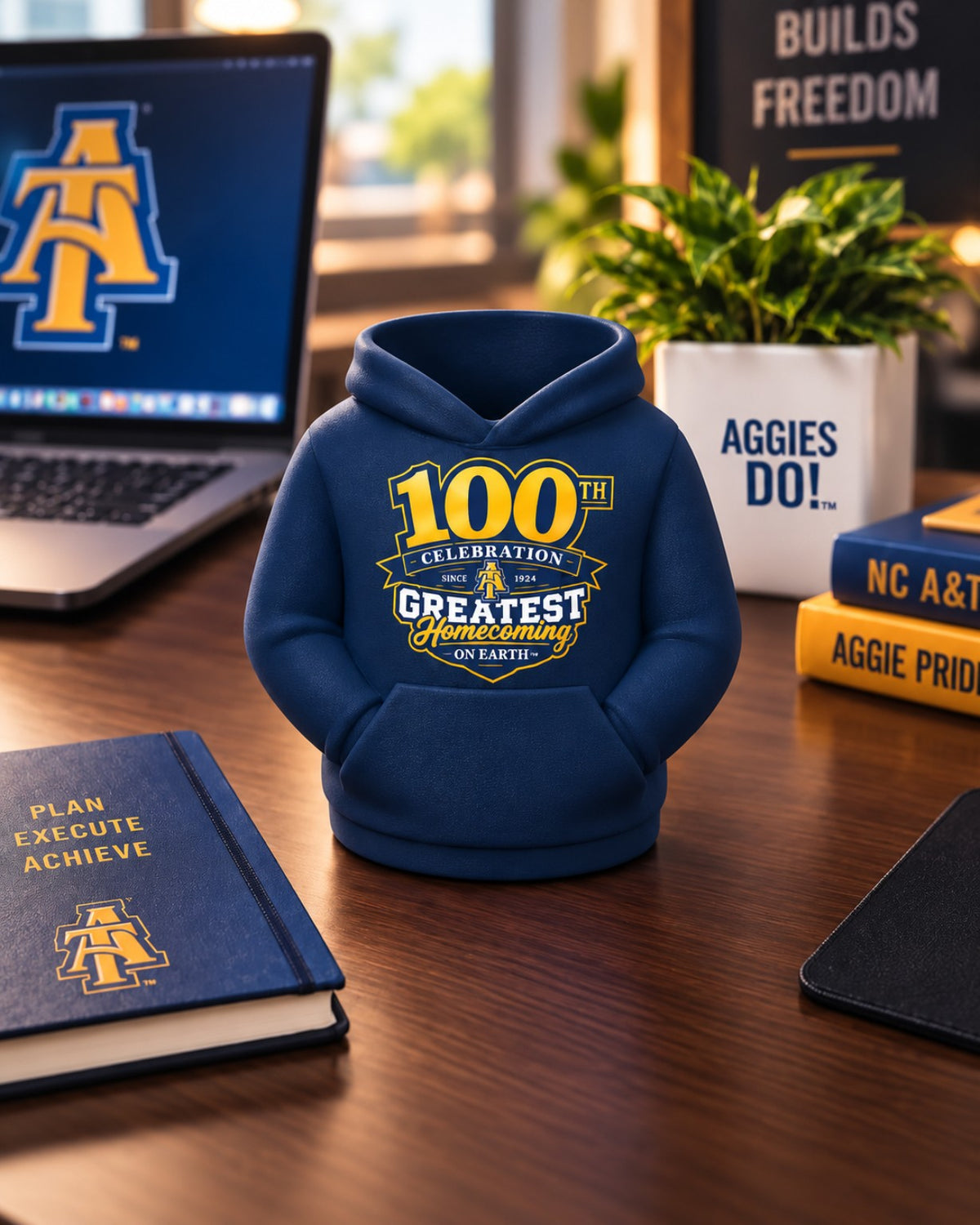 NC A&T 100th Year GHOE hoodie pen holder in matte navy blue on a professional desk