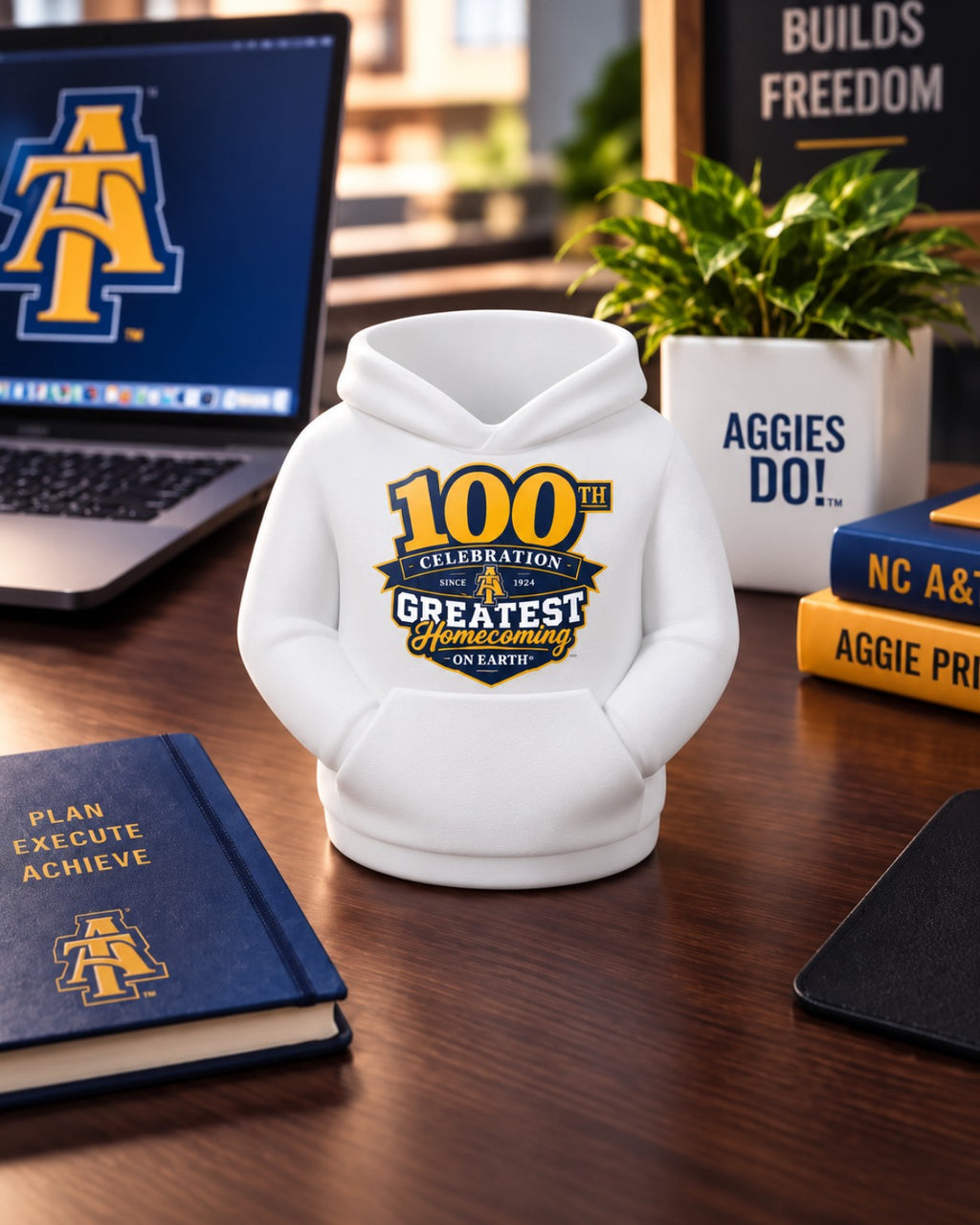 NC A&T 100th Year GHOE hoodie pen holder in white on a professional desk