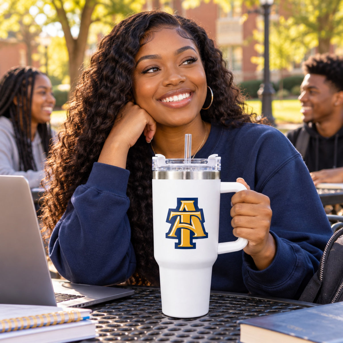 Student holding a white NC A&T 40 oz tumbler on campus