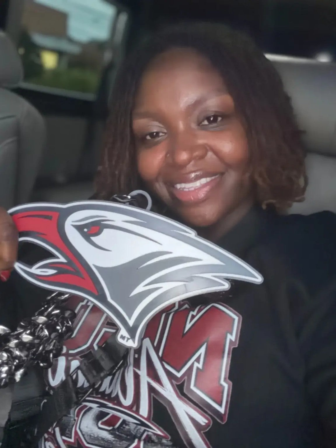 Fan holding the NCCU Eagles Hype Chain pendant